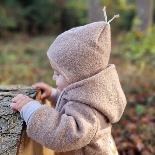 Kind in beiger Wollwalk Jacke mit Kapuze im Herbstwald – handgemacht in Deutschland · Talu-Kids